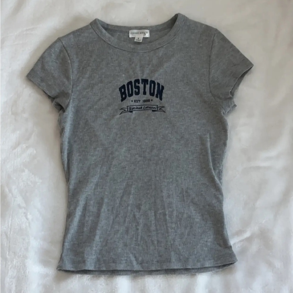 Gray top with navy blue writing on it.